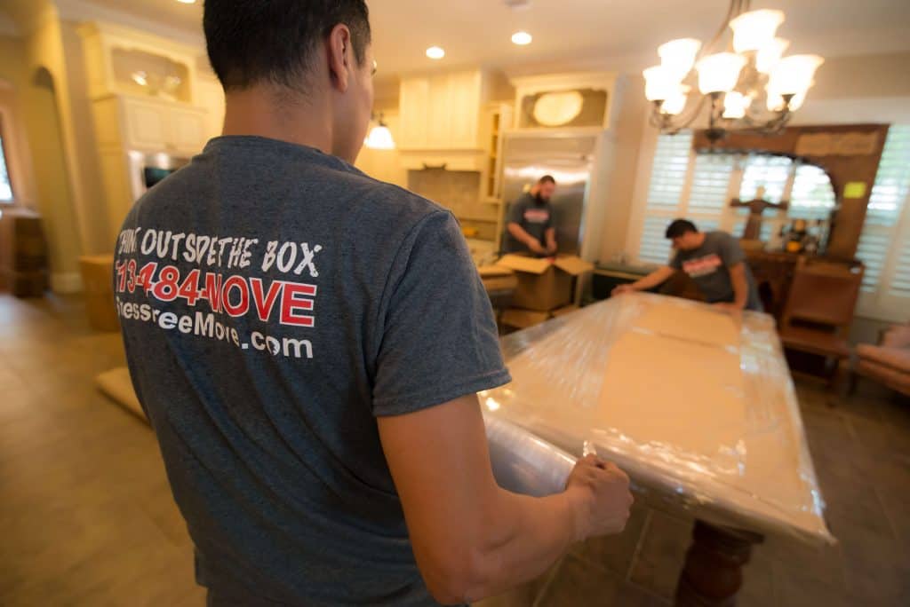 Ameritex furniture movers wrap, protect, and move large table